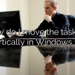 How do I move the taskbar vertically in Windows 11?
